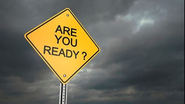 A yellow sign that reads "ARE YOU READY?" surrounded by a dark storm