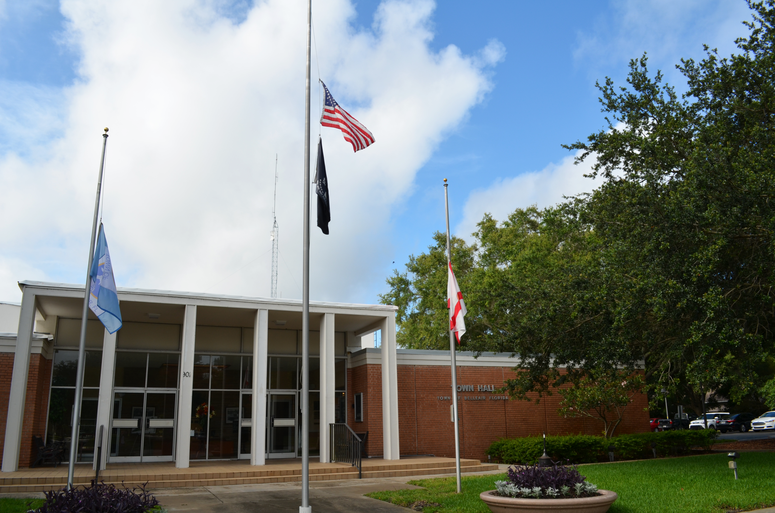 The front of Belleair's Town Hall building with flags at half staff.