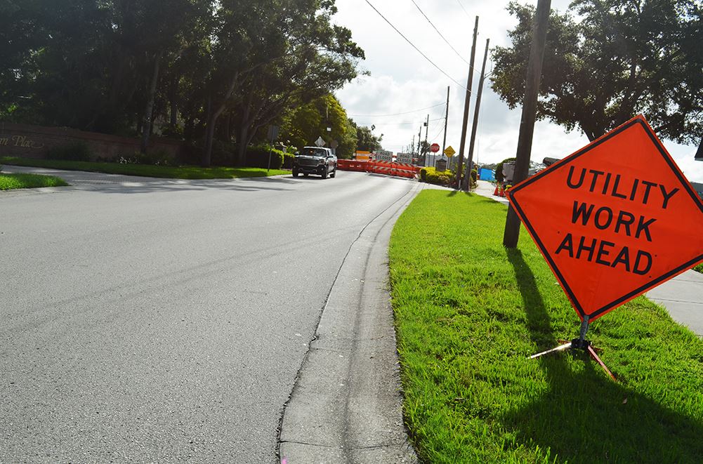 An orange sign on Poinsettia Road before the Pinellas Trail reads 